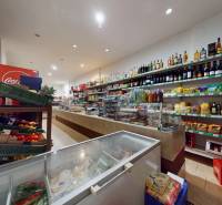Interior of a commercial space with shelves full of groceries and beverages.