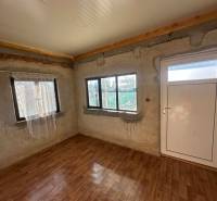 Interior with wood-patterned flooring and white doors in the Gardens section.