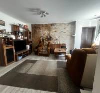 Living room in a family house with comfortable furniture and wooden floor decor.
