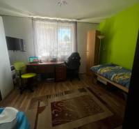 Children's room in a family house with a colorful wall, a desk, and a floor with a wooden decor.