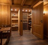 Wooden interior of a wine shop with wine shelves and a floor with a wooden decor.