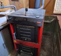 Solid fuel furnace in the basement of a family house, with a connected flue for exhaust gases.