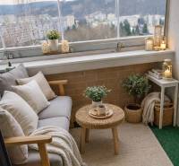 A furnished balcony with seating in a 3-room apartment. Panorama of the city of Čadca in the background.