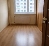A room with a wooden floor decor and a large window in a 3-room apartment.
