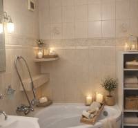 The bathroom in a 3-room apartment with a bathtub, candles, and tiles creates a cozy atmosphere.
