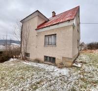 A family house in Poľana in Skalité, surrounded by a winter landscape with a light dusting of snow.