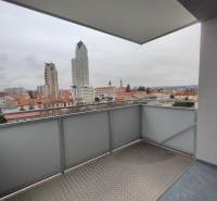 The balcony of a 2-room apartment on Majakovského Street in Lučenec with a city view.
