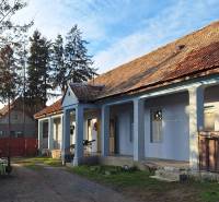 A family house in Rapovce with a gable roof and blue facade.