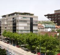 The building on Freedom Square in Bratislava - Old Town, surrounded by trees and cars.