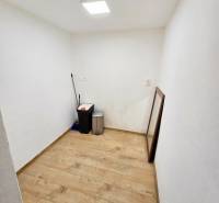 A small room in a one-bedroom apartment with a wooden decor floor.