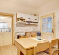 A kitchen in a family house with wooden furniture and a floor with a wooden decor.