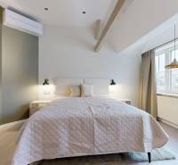 Bright bedroom with a comfortable bed and a window in a 4-room apartment.