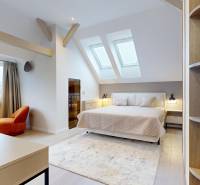 Bright bedroom in a 4-room apartment with wood-patterned flooring and large skylights.