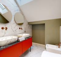 A bathroom with sinks on a marble countertop and green walls in a 4-room apartment.