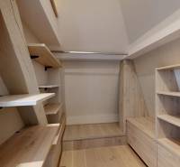 Storage space in a 4-room apartment with wood-patterned flooring and shelves.