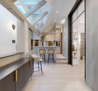 Interior of a 4-room apartment with a wooden decor floor, ceiling beams, and a kitchen counter.