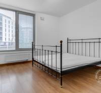 Bedroom in a 3-room apartment with a metal bed and a floor with a wood decor.