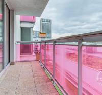 A balcony with pink railings and tiles at a 3-room apartment on Staré Grunty, Bratislava.