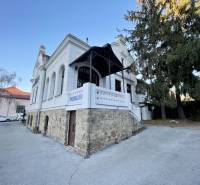 The building on Vajanského Street in Prešov with an elegant stone base and a white facade.