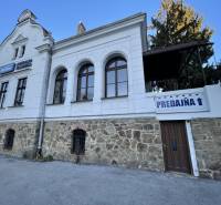The building on Vajanského Street in Prešov with a stone ground floor and the inscription 