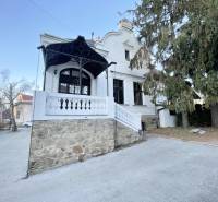 The building on Vajanského Street in Prešov with a stone terrace and trees.