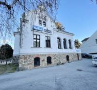 The building on Vajanského Street in Prešov with a stone ground floor and a white facade.