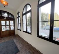 A building with a wooden decor floor and large windows on Vajanského Street in Prešov.