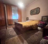 Bedroom in a family house with carpets, a bed, and a floor with a wood decor.