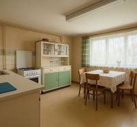 Retro kitchen with dining table and chairs in a family house.