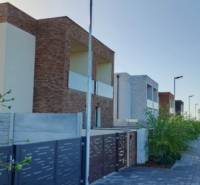 Modern apartment buildings in Diakovce with private parking and landscaped greenery.