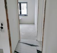 Interior renovation of a family house with white walls and marble flooring.