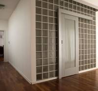 Interior of a family house with glass doors and a wooden decor floor.
