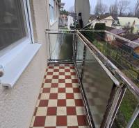 A balcony with a checkered floor overlooking the gardens on Sadová Street in Piešťany.