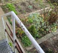 A garden with flowers and a metal railing on Sadová Street in Piešťany.