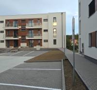 Apartment complex on Banka Street in Piešťany with parking spaces and modern facades.