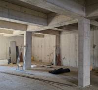 A concrete structure under construction with materials and tools in a 3-room apartment.