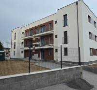 Apartment building on Banka Street in Piešťany with a garden and balconies.