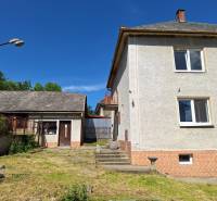 A family house in Šíd with an adjacent garden and an annex, under the blue sky.