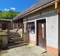 A family house in Šíd with an old courtyard, staircase, and neglected exterior details.