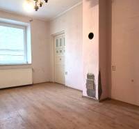 A room in a family house with a wooden decor floor and a window, for renovation.