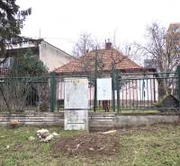 A family house on 29th August Street in Levice, surrounded by a garden and a fence.