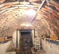 A cellar with a brick vault in a family house, full of canning jars.