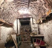 A traditional cellar in a family house, full of preserves and antique furniture.