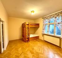 A bedroom in a 4-room apartment with a bunk bed and a floor with a wooden decor.