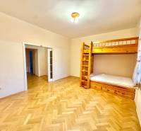 A room in a 4-room apartment with a bunk bed and a floor with a wooden decor.