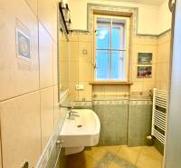Bathroom with tiles, shower, and sink in a 4-room apartment.