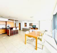 A bright kitchen with a dining table and large windows in a 4-room apartment.