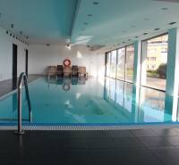 Indoor pool with loungers in a 4-room apartment.