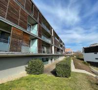 An apartment building with wooden elements and a garden in Bratislava - Nové Mesto on Na Zlatej nohe Street.