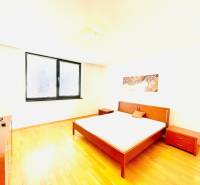 A bright bedroom with stylish furniture and a wood-patterned floor in a 4-room apartment.